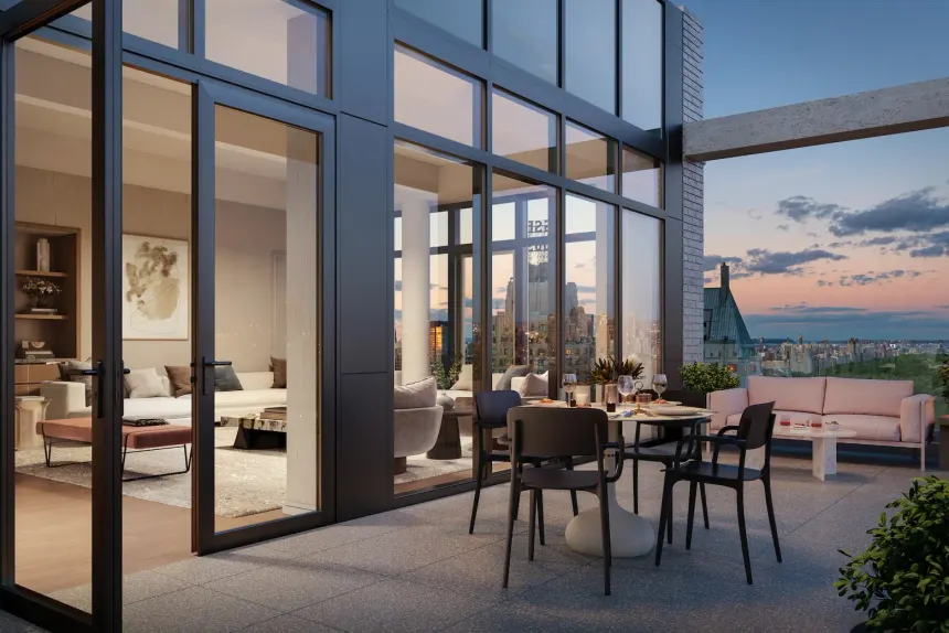 Condominium tower terrace and common-area amenity overlooking a city skyline at dusk